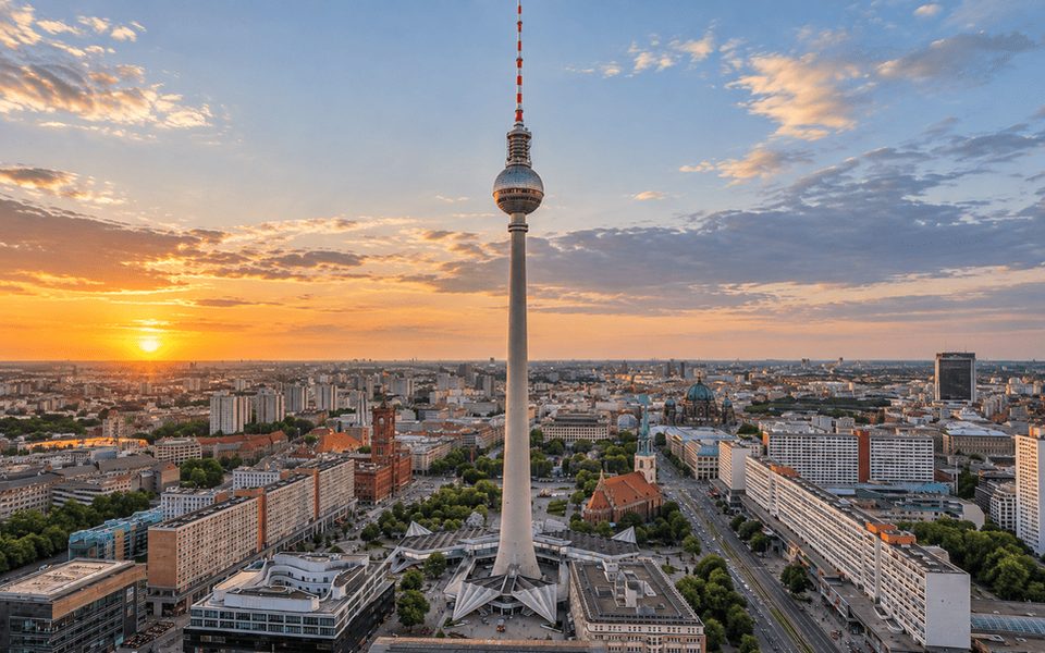 Berlin Television Tower rising over the cityscape at sunset