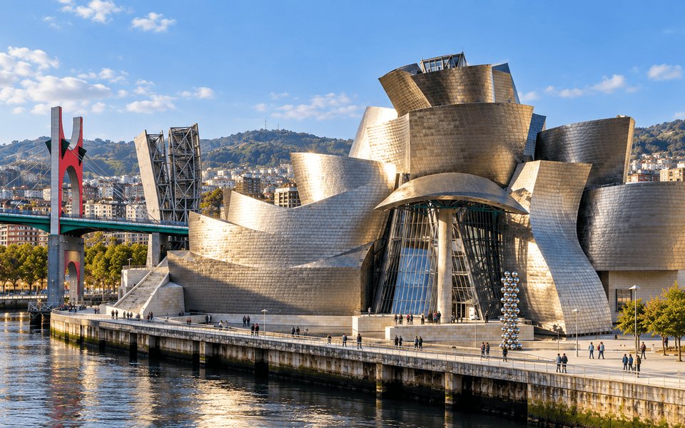 Guggenheim Museum Bilbao and the Maman spider sculpture along the Nervión River under a clear sky
