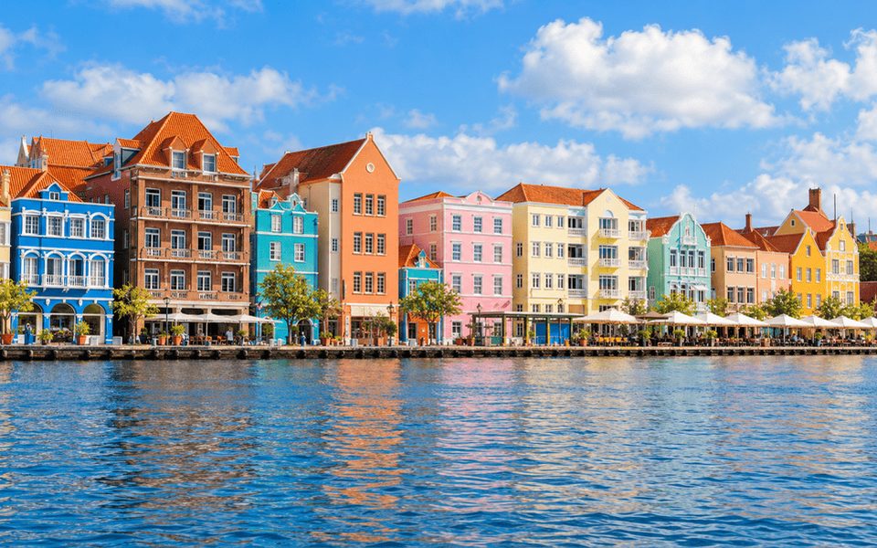 Colourful Dutch colonial Handelskade buildings reflected in Willemstad harbour, Curaçao
