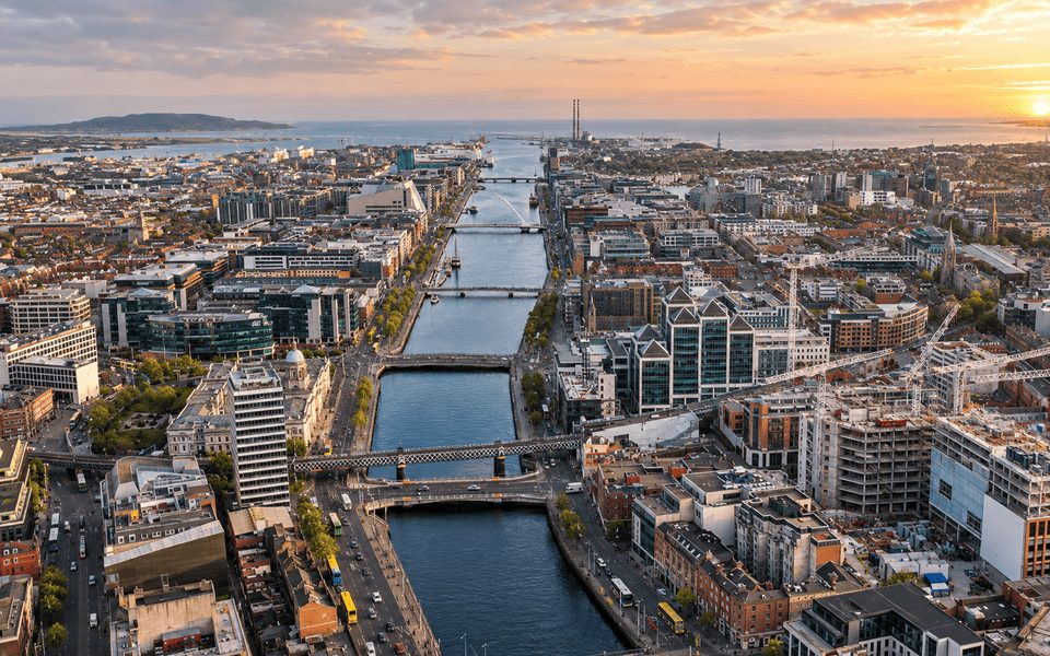 Aerial view along the River Liffey in Dublin toward Dublin Bay at golden hour