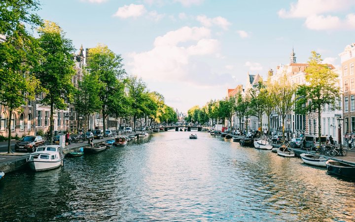 Boats on an Amsterdam canal used for the Europe from Australia flight alert banner