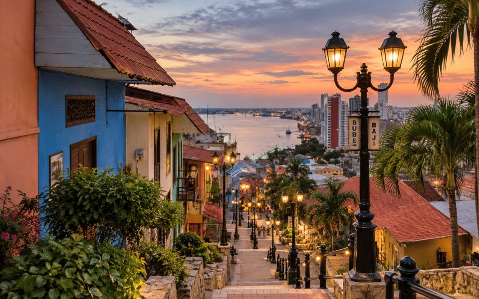 Sunset looking down the colourful Las Peñas staircase on Santa Ana Hill in Guayaquil toward the Guayas River and city skyline