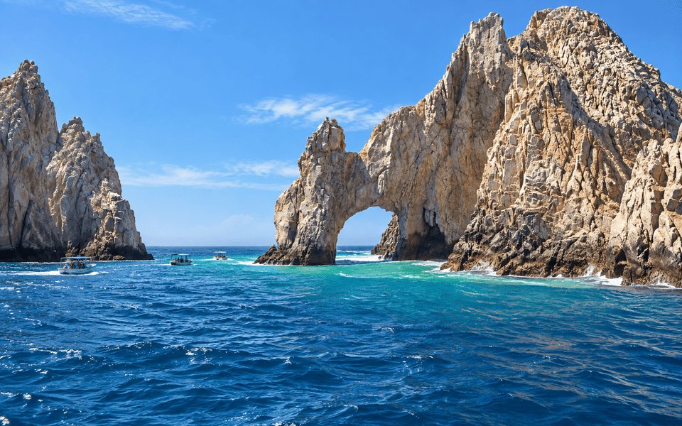 El Arco natural limestone arch at Land's End in Cabo San Lucas with turquoise water and tour boats