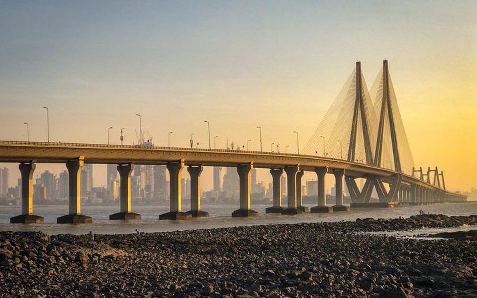 Bandra-Worli Sea Link cable-stayed bridge over the water at golden hour with the Mumbai skyline beyond