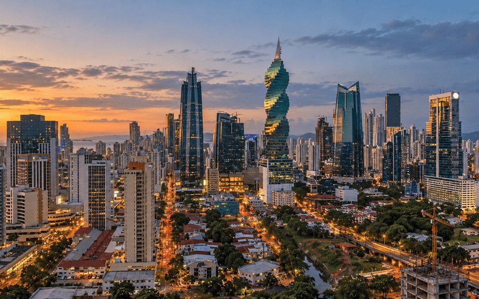Panama City skyline at sunset with the twisting F&F Tower above the glowing streets
