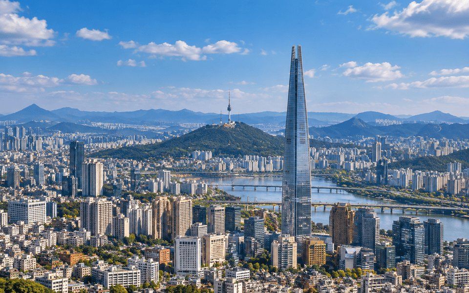 Seoul daytime skyline with Lotte World Tower rising above the Han River and Namsan in the distance
