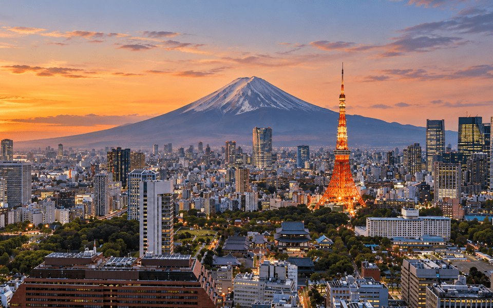 Sunset view of the Tokyo skyline with illuminated Tokyo Tower and snow-capped Mount Fuji in the background