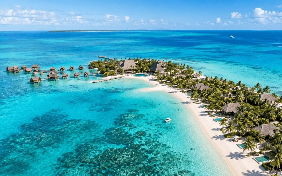 Turquoise Caribbean lagoon and overwater bungalows for a warm January escape from the U.S.